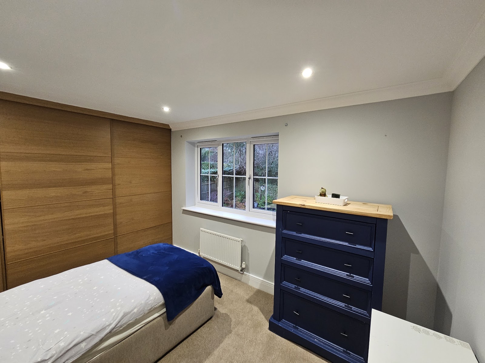 Bedroom with navy drawers by H&C Cleaning and Maintenance in Hailsham
